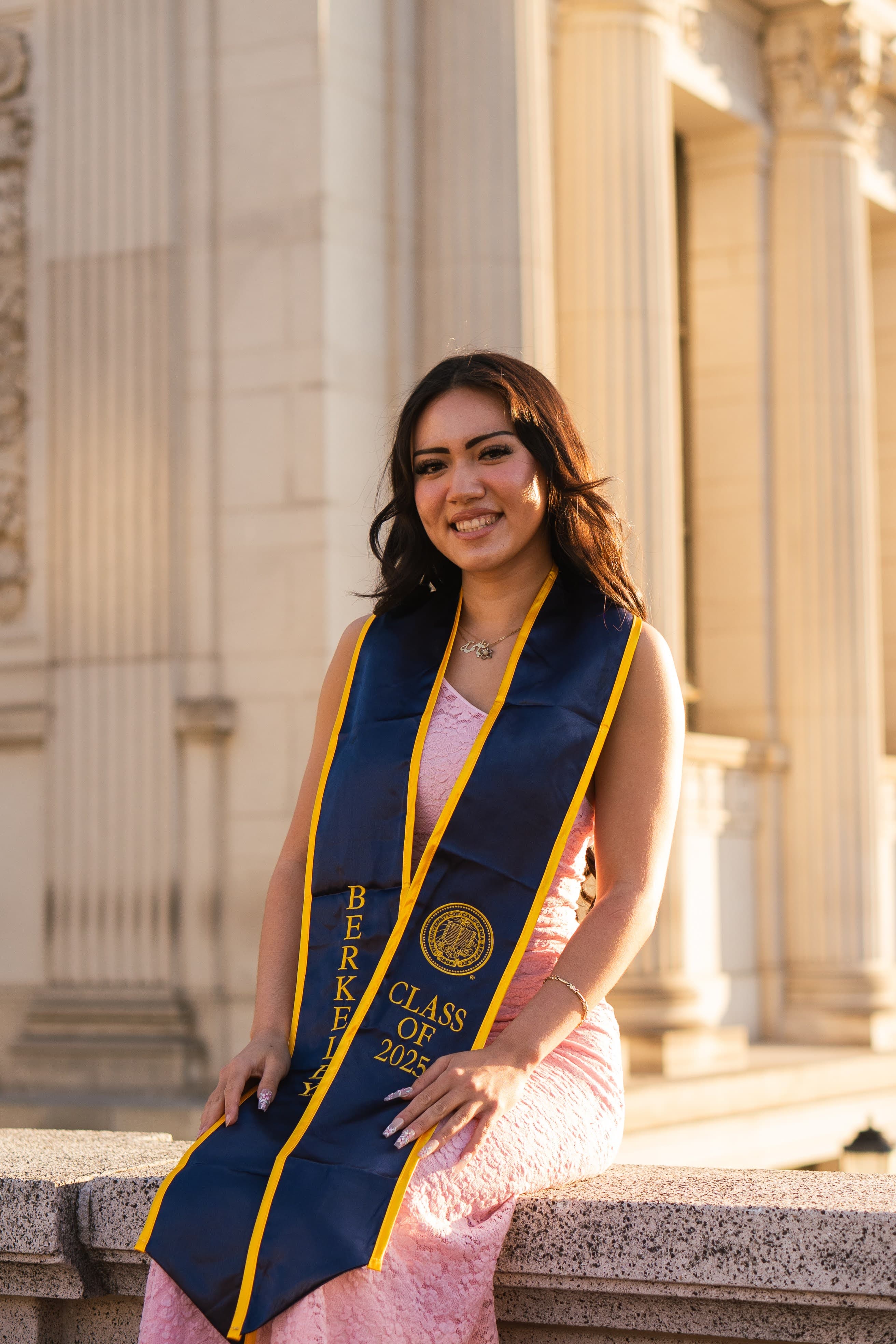 Graduate portrait against stone wall
